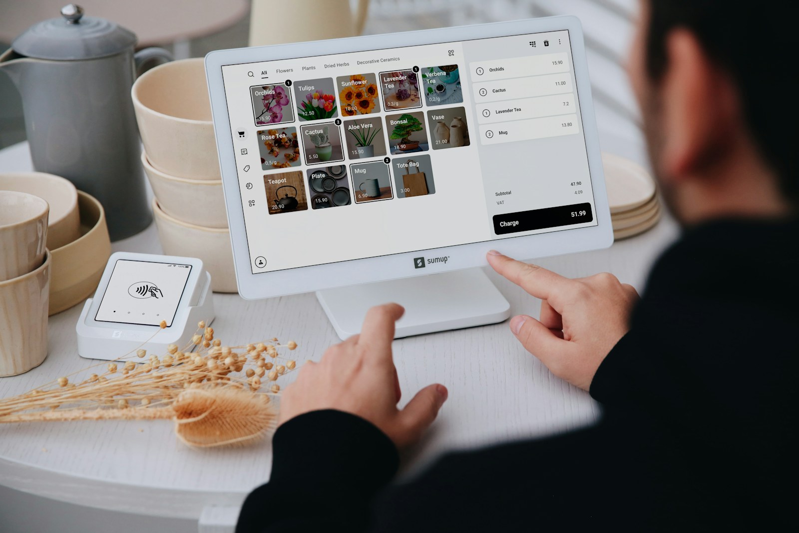 Cashier using a modern point of sale system at a retail checkout